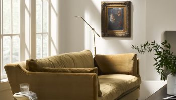 Rowe - Olive Green Velvet Sofa With Wooden Legs Near Large Windows And Framed Art