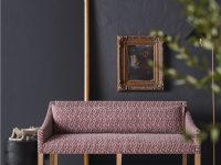 Rowe - Pink Patterned Sofa With Wooden Legs On Cowhide Rug Near Gold Mirror And Framed Art