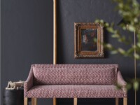Rowe - Pink Patterned Sofa With Wooden Legs On Cowhide Rug Near Gold Mirror And Framed Art