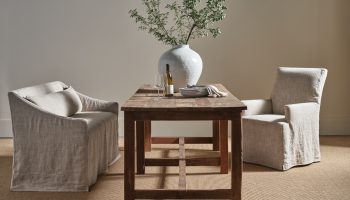 Rowe - Rustic Wooden Table With Two Beige Slipcovered Armchairs, White Vase With Greenery, Home Decor