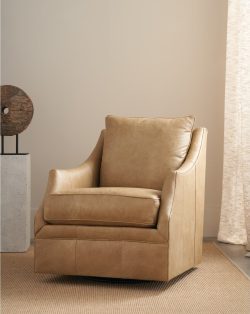 Rowe - Tan Leather Swivel Chair With Plush Cushions On Woven Rug Near Abstract Sculpture