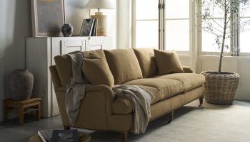 Rowe - Tan Upholstered Sofa With Plush Cushions Under Large Window Near White Console Table Home Decor