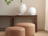 Rowe - Two Brown Leather Ottomans Under Wooden Console Table With White Vases And Greenery Home Decor