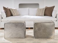 Rowe - Two Grey Cowhide Ottomans In Front Of White Sofa With Brown And Striped Pillows Home Decor