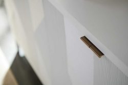 Rowe - White Cabinet With Brass Handle And Ribbed Panel Door In Modern Home Decor