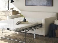 Rowe - White Sleeper Sofa With Pull-Out Mattress Near Wooden Dresser And Wicker Basket, Home Decor