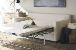 Rowe - White Sleeper Sofa With Pull-Out Mattress Near Wooden Dresser And Wicker Basket, Home Decor