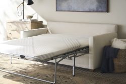 Rowe - White Sofa Bed With Pull-Out Mattress Under Wooden Console Table Near Large Mirror