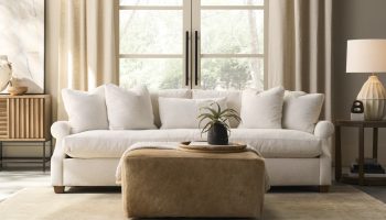 Rowe - White Sofa With Plush Cushions Under Large Window Near Wooden Console Table, Beige Ottoman, Home Decor