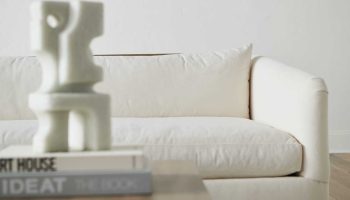 Rowe - White Sofa With Plush Cushions Under Wooden Console Table With Books Home Decor