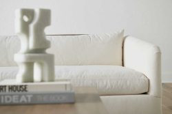 Rowe - White Sofa With Plush Cushions Under Wooden Console Table With Books Home Decor