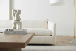 Rowe - White Sofa With Wooden Coffee Table Near Modern Sculpture And Floor Lamp In Minimalist Home Decor