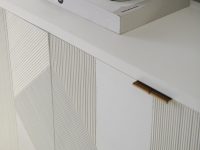 Rowe - White console table with geometric ribbed panel doors, topped with a white bowl and a book
