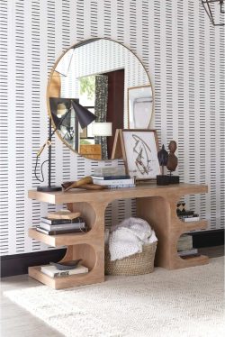 Rowe - Wooden Console Table With Books And Decor Under Large Round Mirror Near Striped Wallpaper