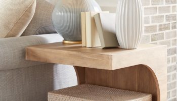 Rowe - Wooden Side Table With White Lamp, White Vase With Flowers, Books, And Woven Box Under Console Table Near Brick Wall