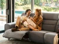 Content couple relaxing on light grey Stressless Emily Wide sofa