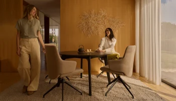 Friends enjoying tea at Stressless Laurel dining chairs in light beige