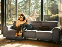 Mother hugging child on grey Stressless Emily sofa